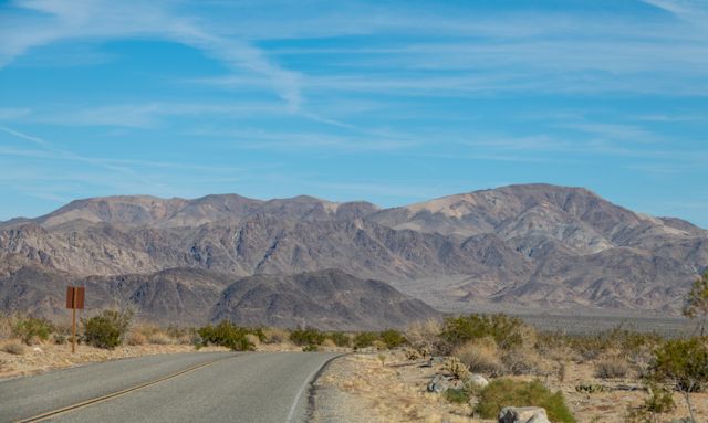An open desert highway stretching toward distant mountains